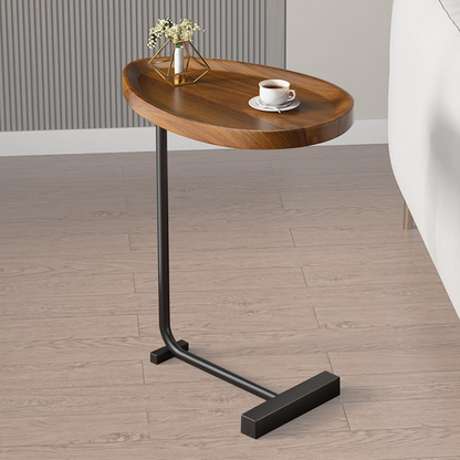Wooden side table with black metal leg on a wooden floor