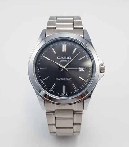 Casio watch with black dial and silver metal strap on a white background
